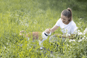 Lily and human in field with Tractive GPS CAT 4/LTE