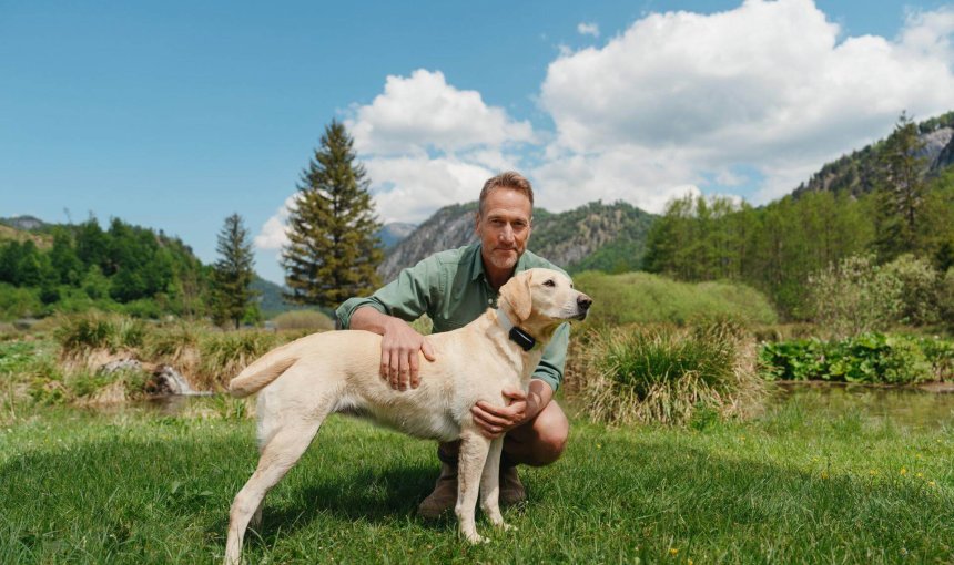 Ben Fogle outside with a dog wearing a Tractive Smart Dog Tracker