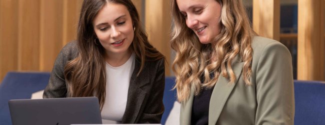 A pair of Tractive employees working together on a project