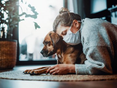 Dog and woman with face mask - can dogs get coronavirus?