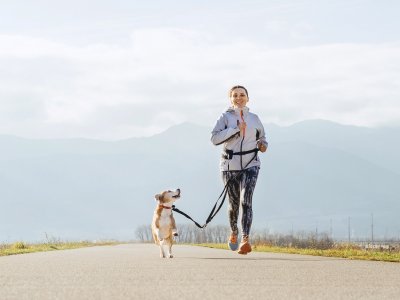 woman running with dog outside