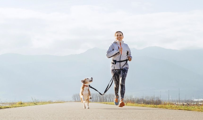 woman running with dog outside