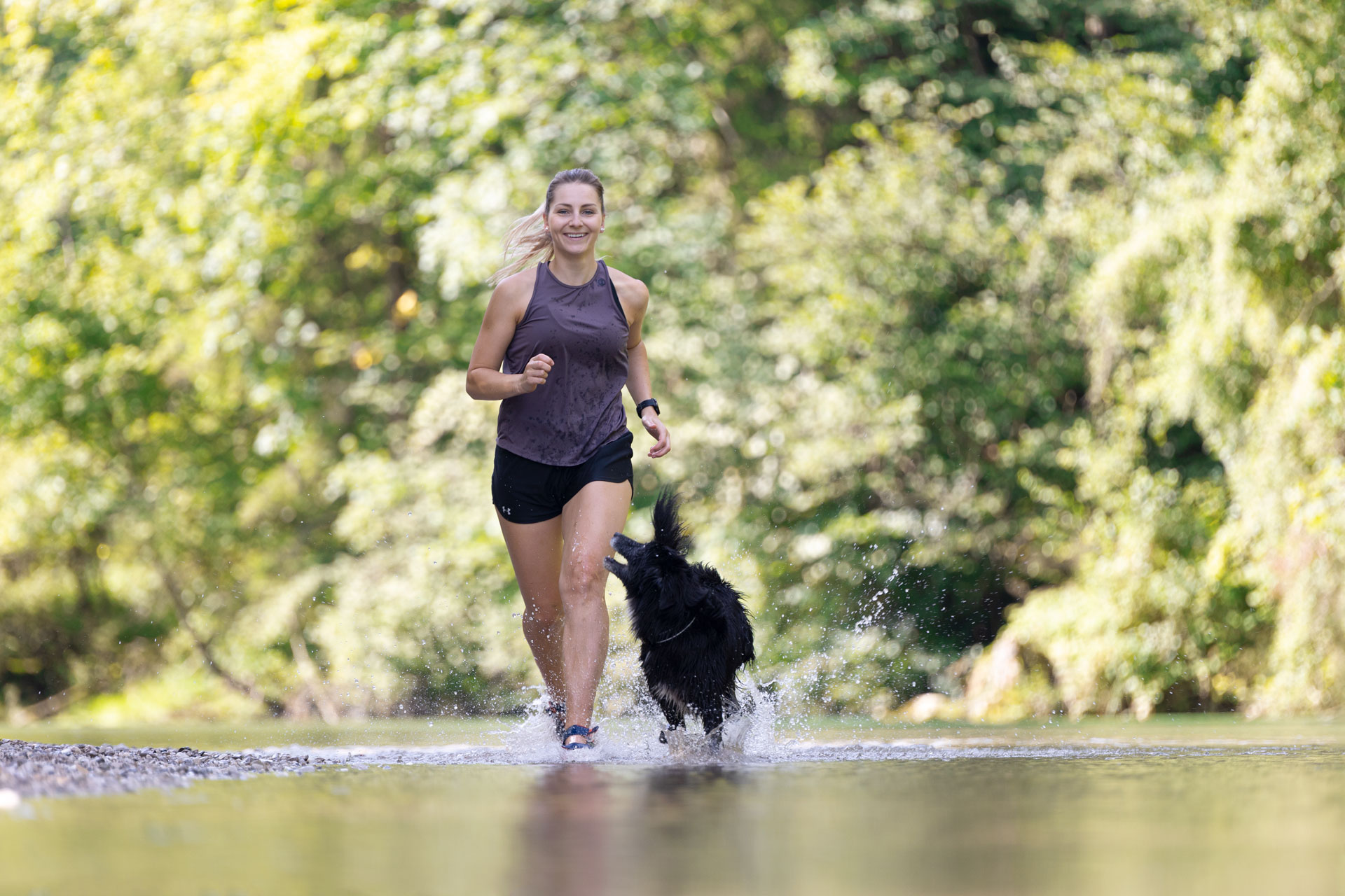 woman running outdoors with dog