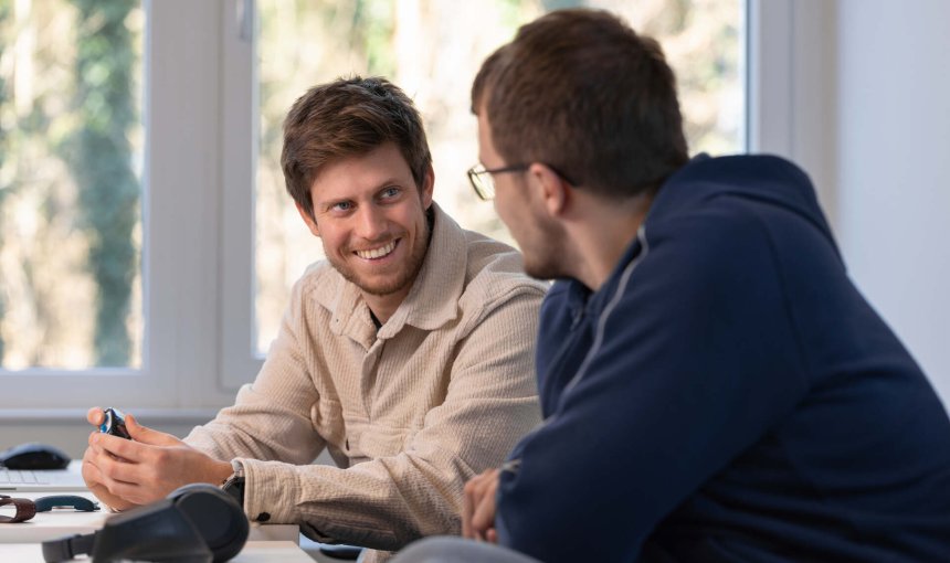 A pair of Tractive employees discussing work