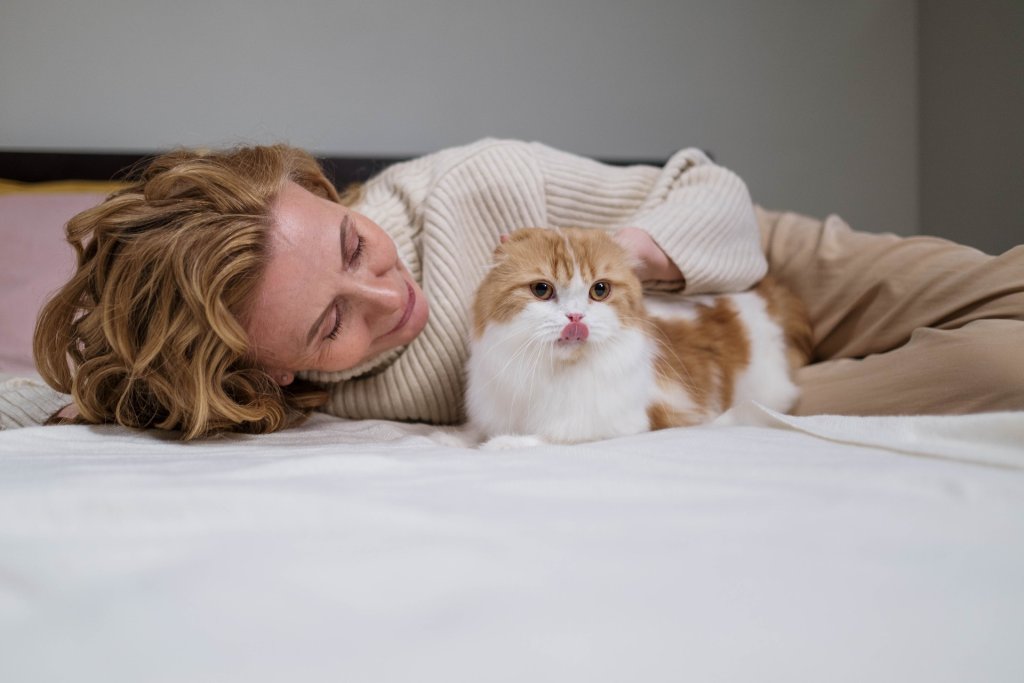 A woman comforts her cat in a safe, quiet environment.