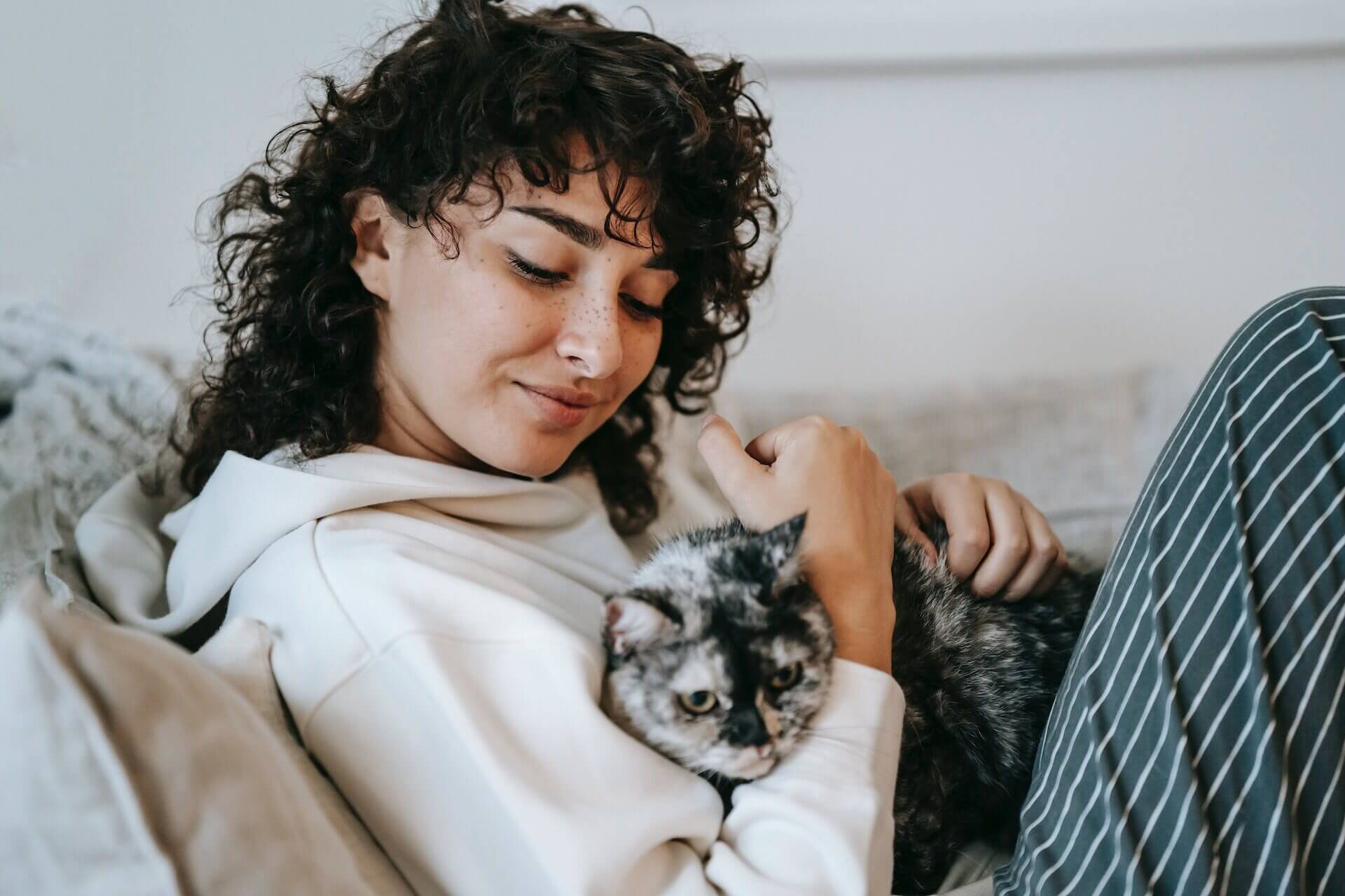 A woman cuddling with her cat