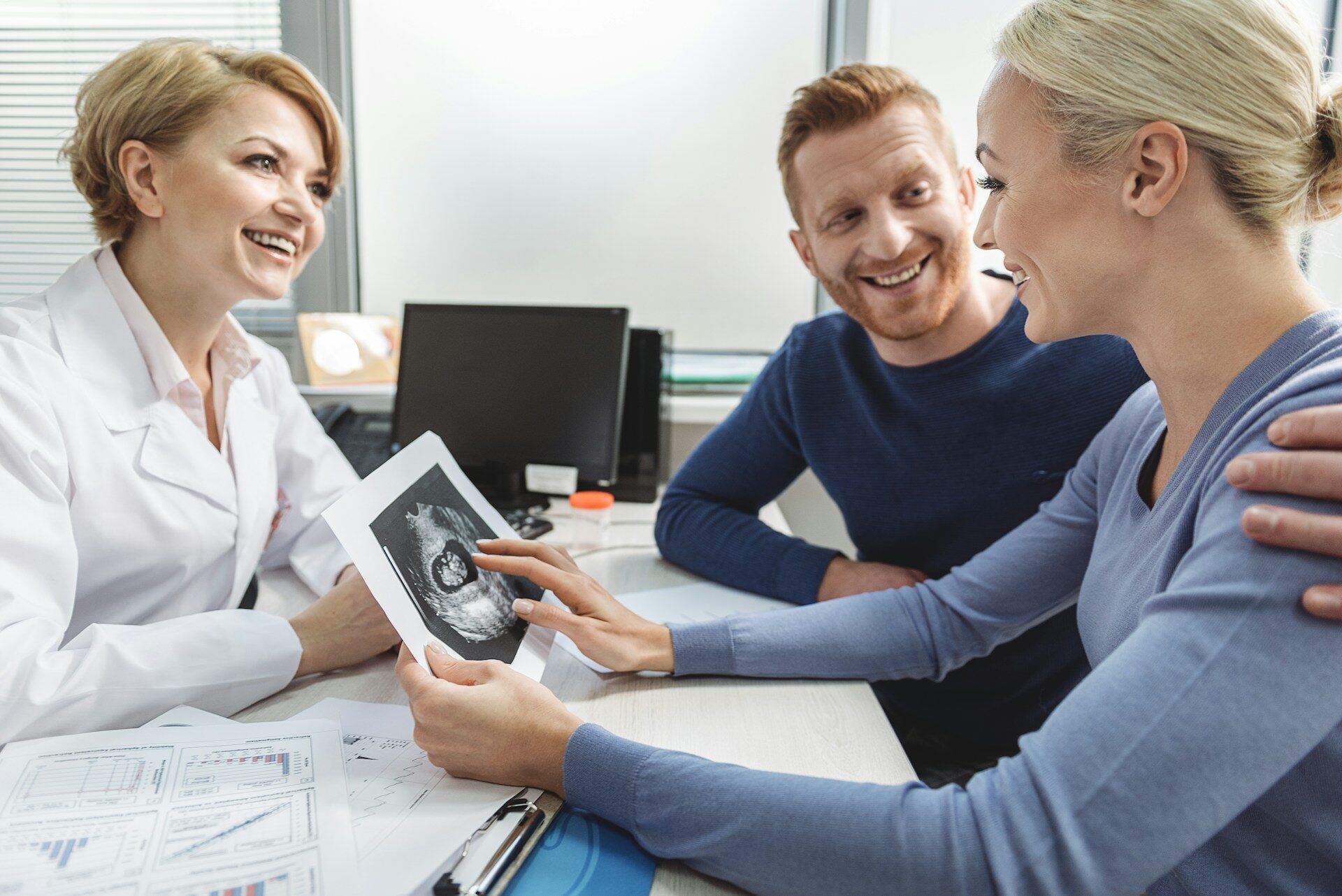 A couple checking an ultrasound image at a doctor's office