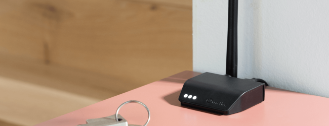 Tractive Base Station sits on a table next to keys