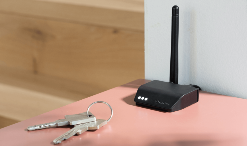 Tractive Base Station sits on a table next to keys
