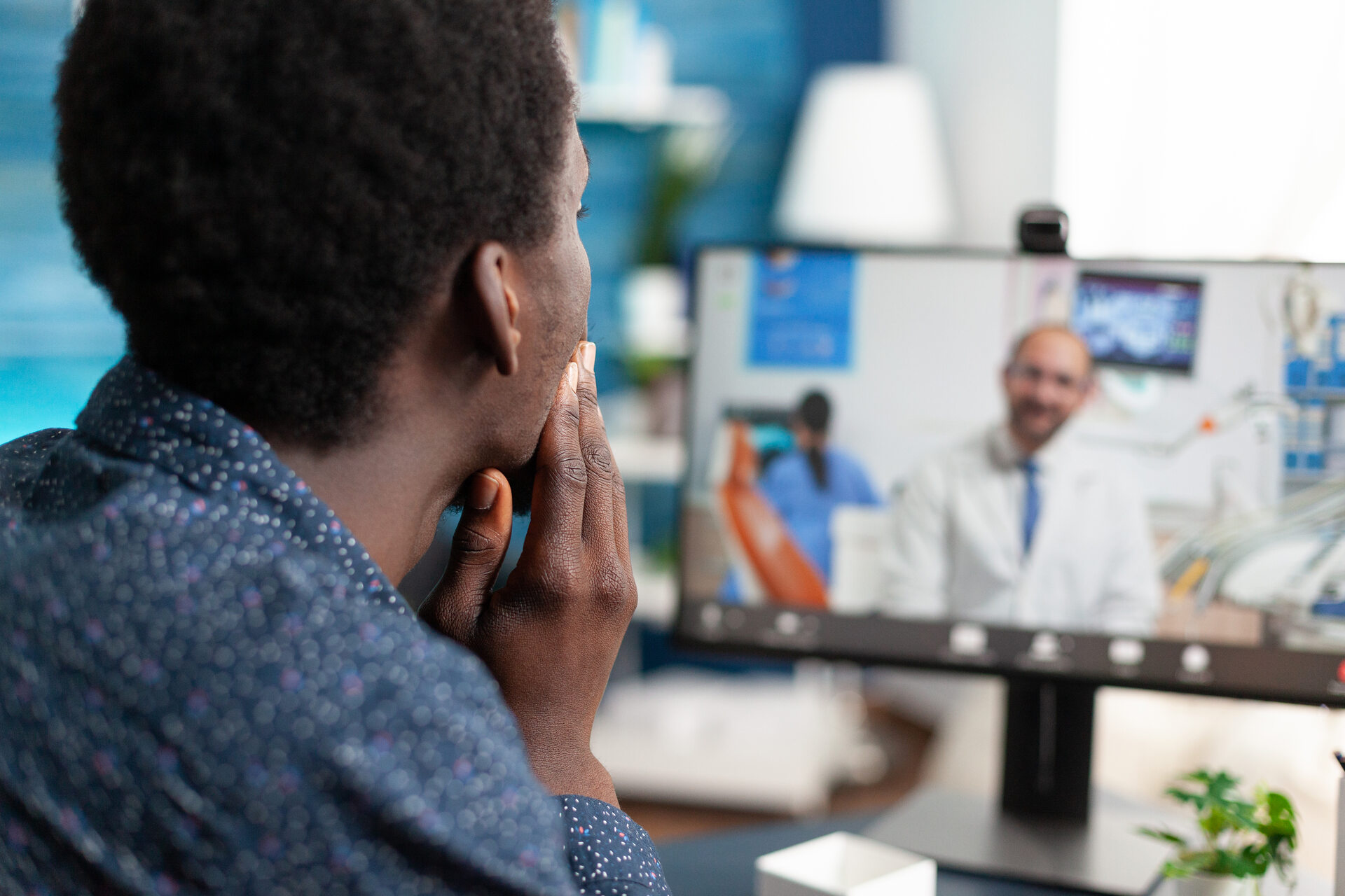 A man speaking to a vet over a video call