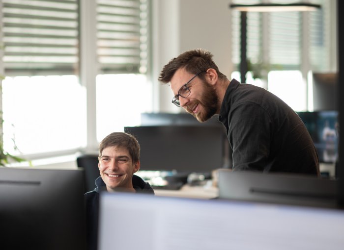 A pair of Tractive employees working together on a project