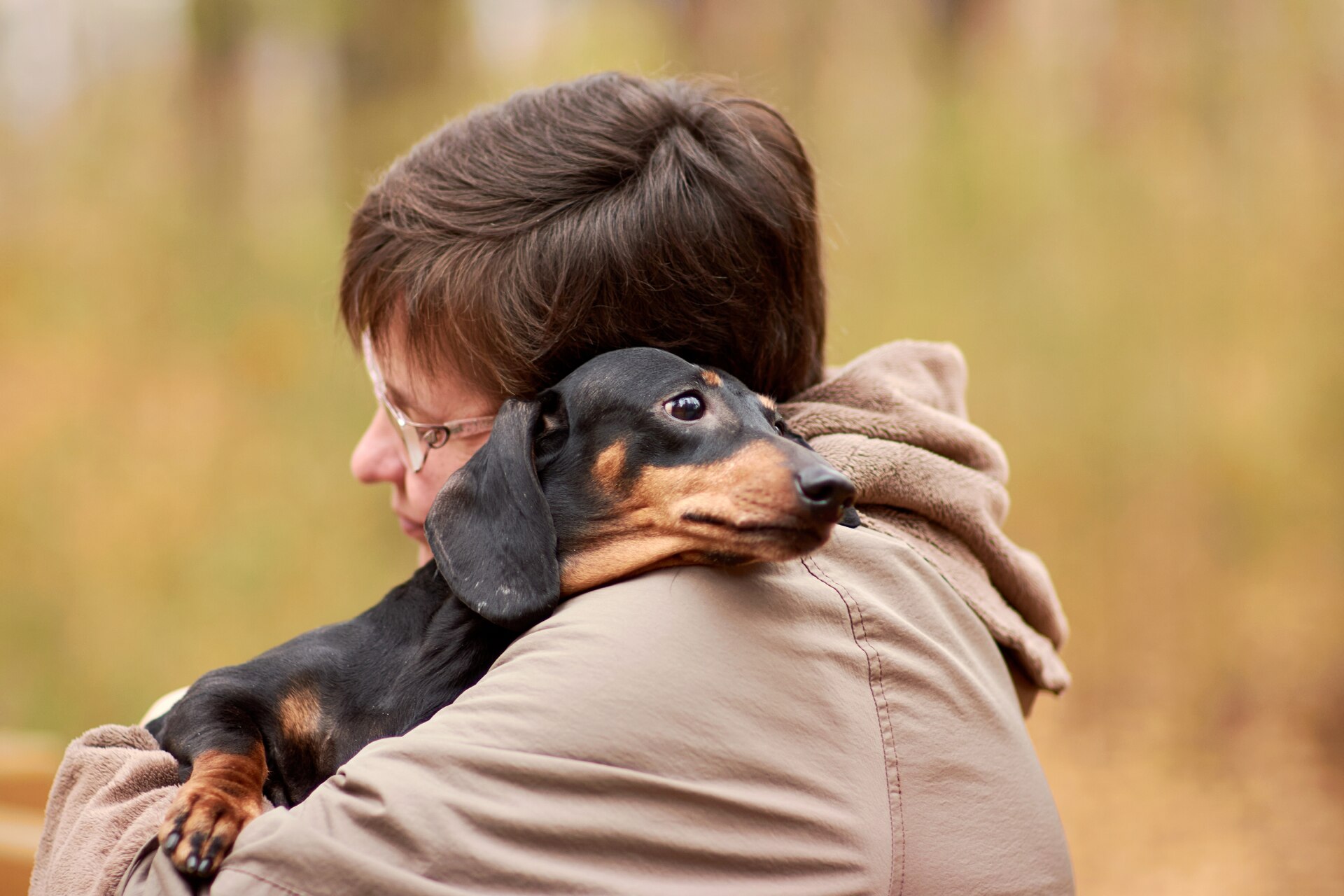 A woman hugging a sick dog