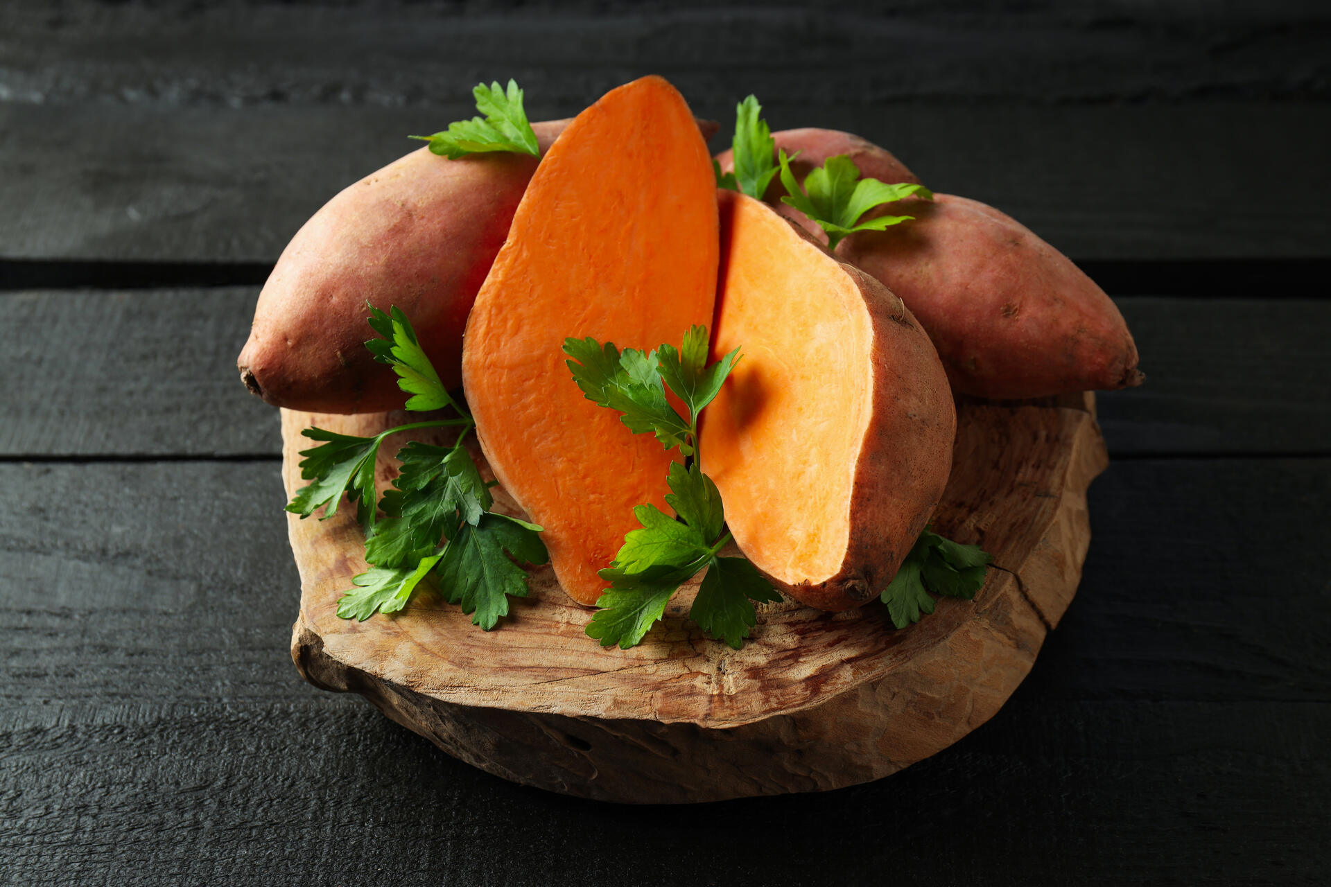 A plate of sweet potatoes on a wooden table
