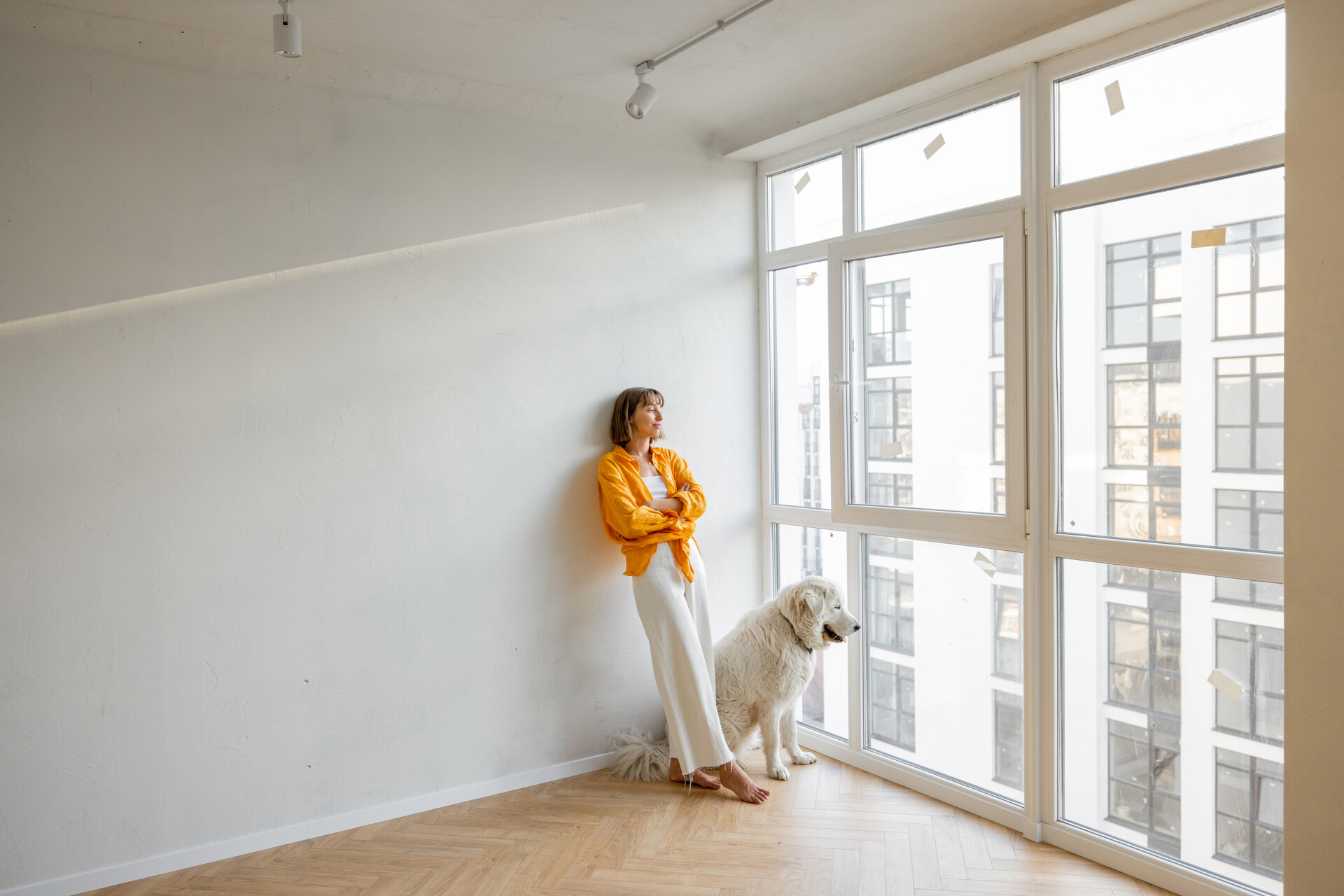A woman and dog in a new unfurnished apartment