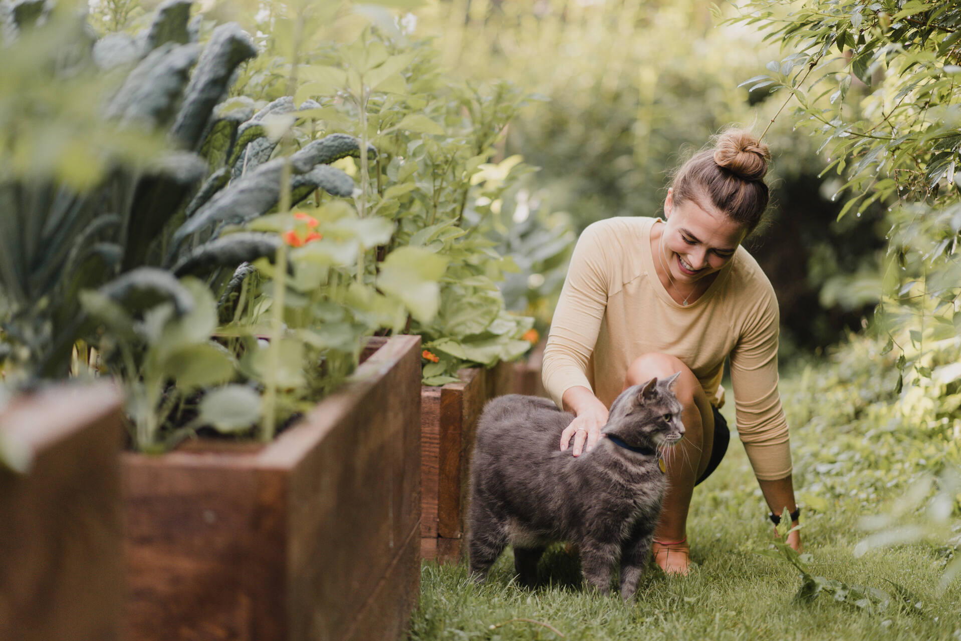 A woman gardening with her cat