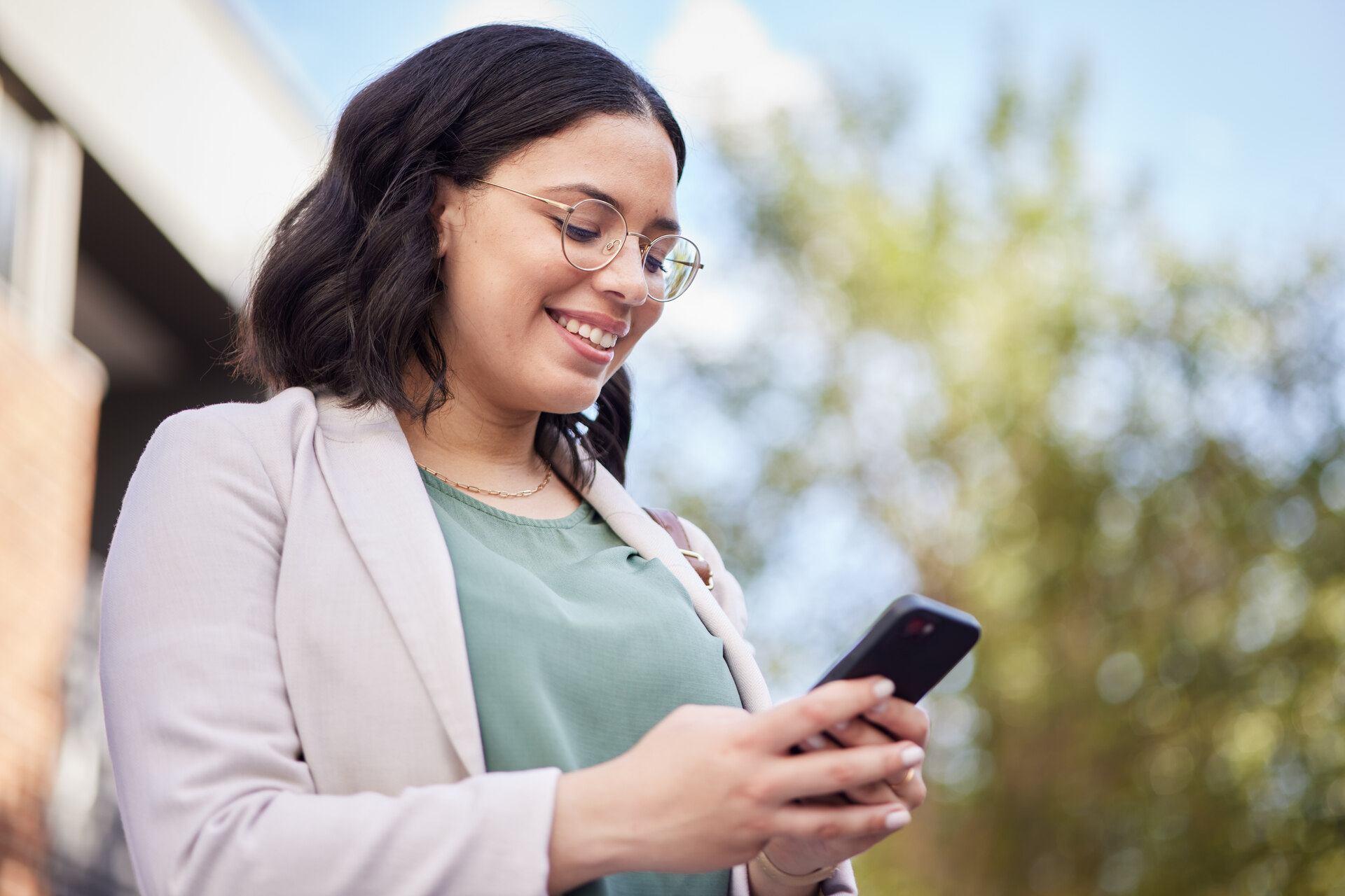 A woman updating her website profile via her smartphone