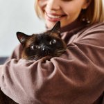 A woman hugging her cat