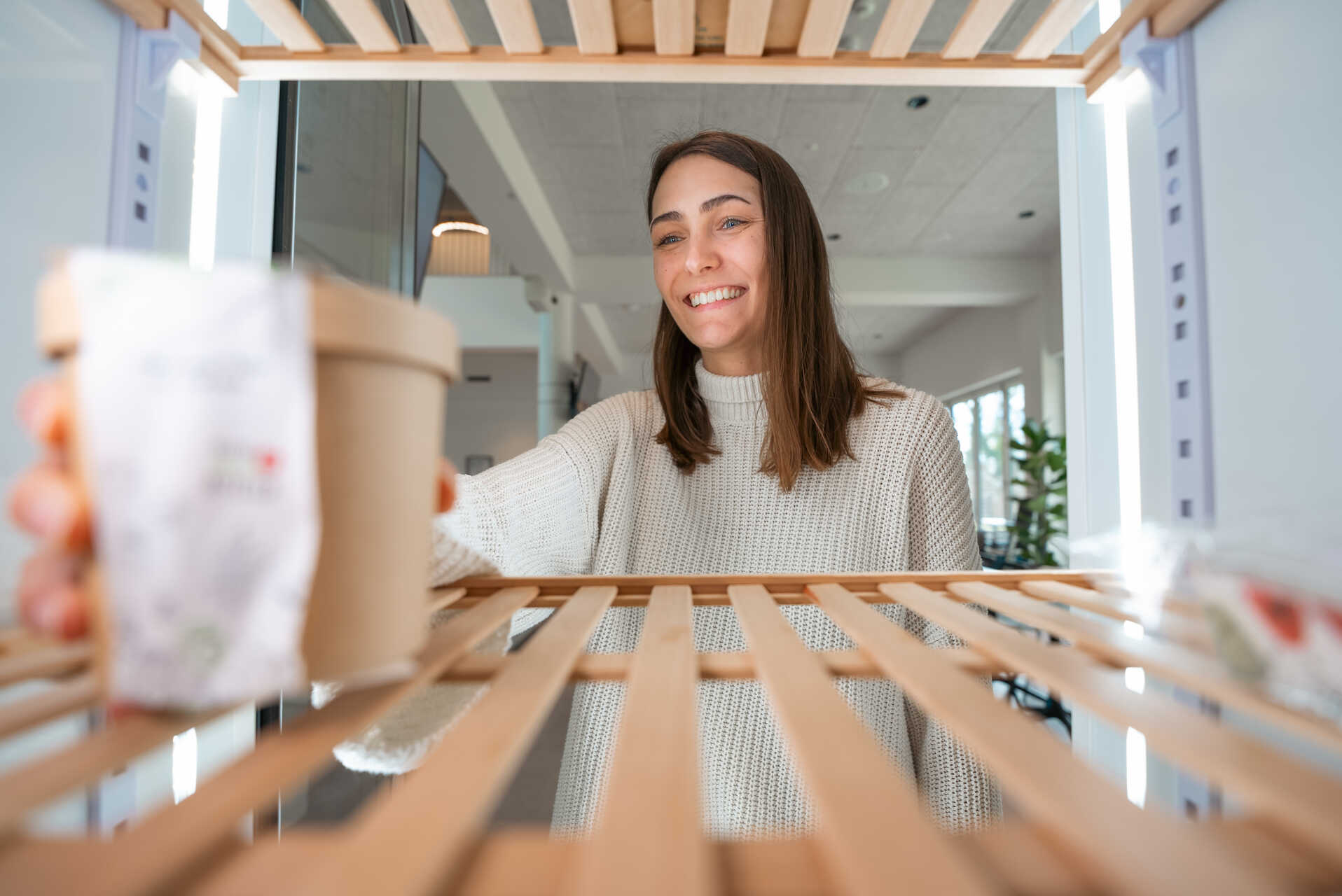 A Tractive employee fetching a meal from the Schrankerl cabinet