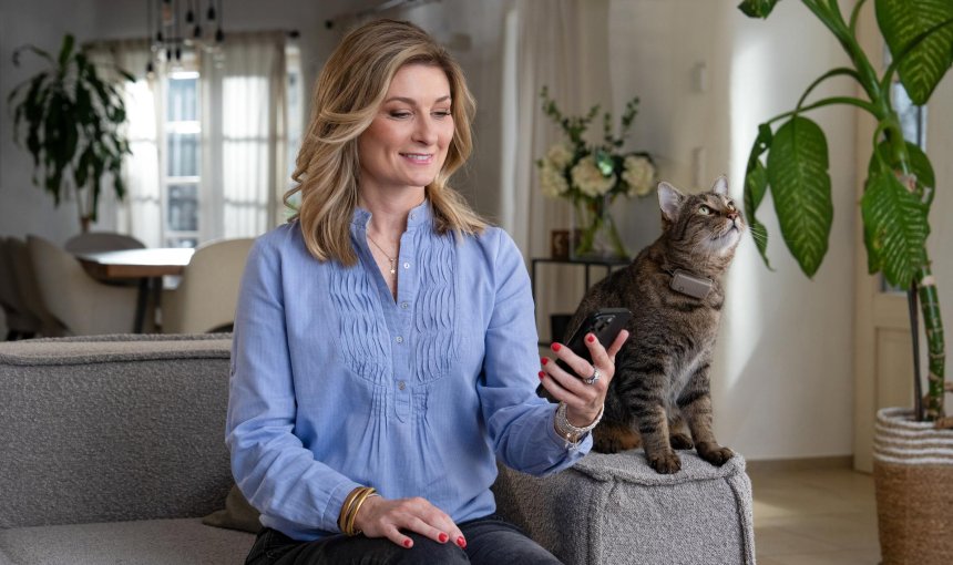 Woman with cat sitting next to her
