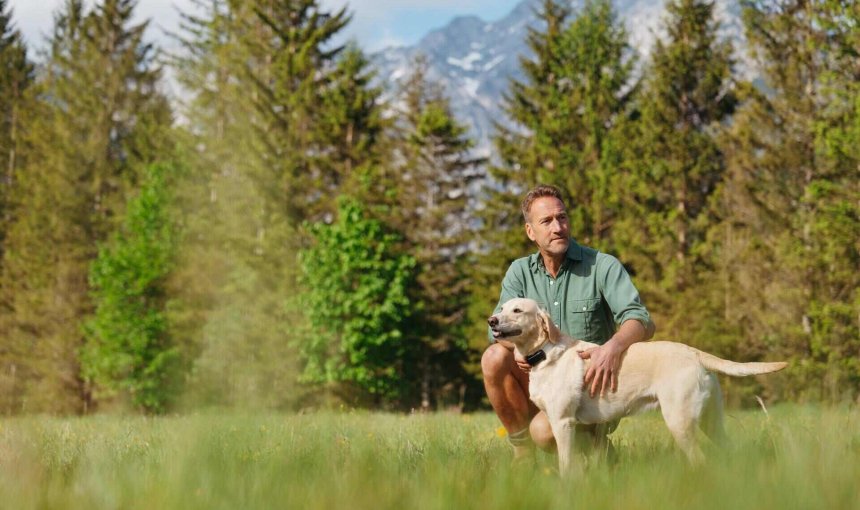 A man training his dog outdoors